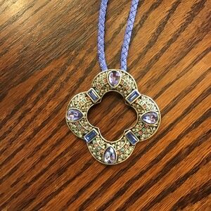 Purple leather like necklace.